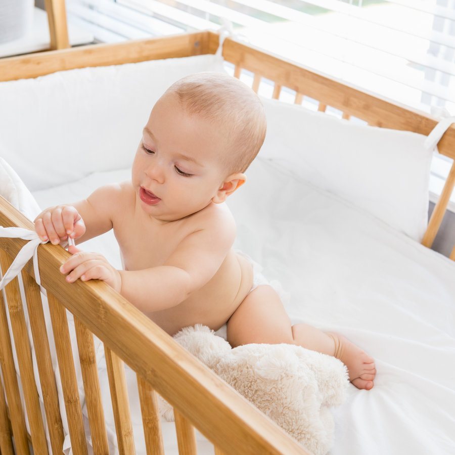 Baby in a wooden crib
